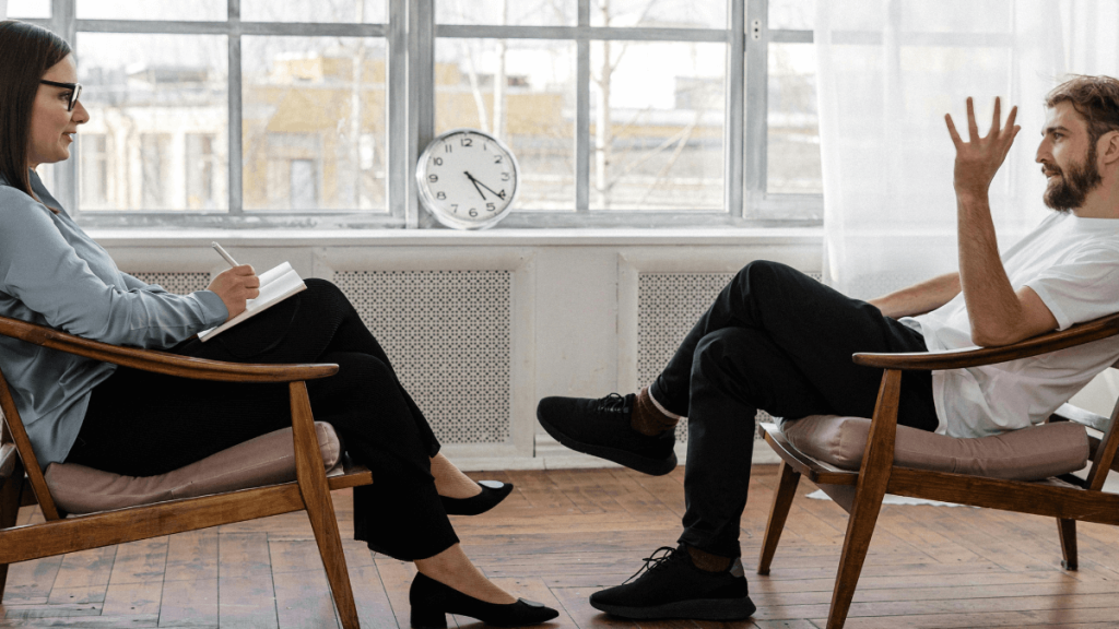 Woman meditating in therapy – PTSD hypnotherapy for trauma recovery